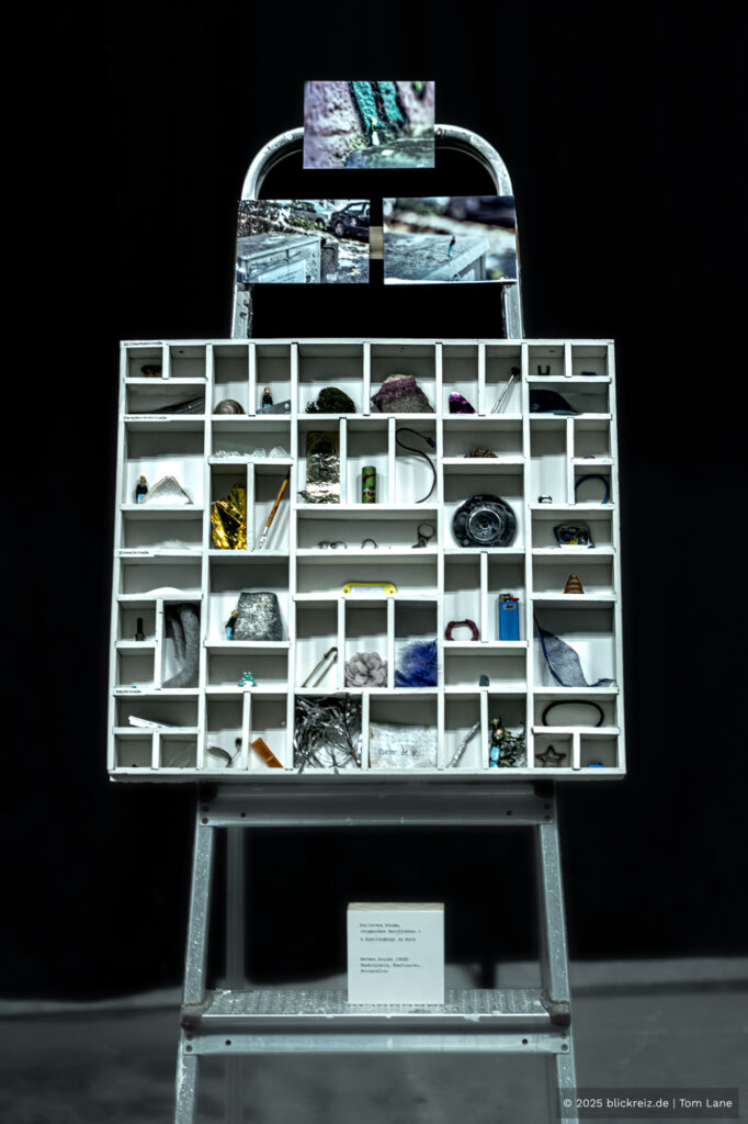 Kunstinstallation aus Regalfächern mit Fotografien bei der Kalk Kunst 2025 in Köln-Kalk, organisiert von der Stiftung KalkGestalten.