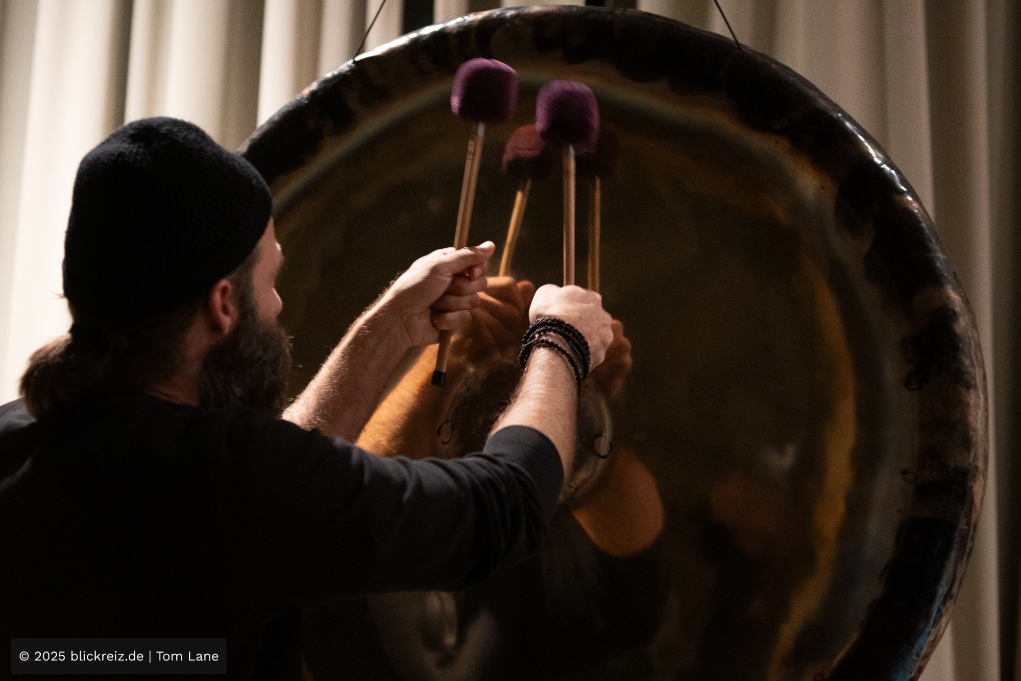 Angelos Gavrias spielt mit mehreren Schlägeln seinen großen Gong und erzeugt ein intensiv spürbaren Sound.